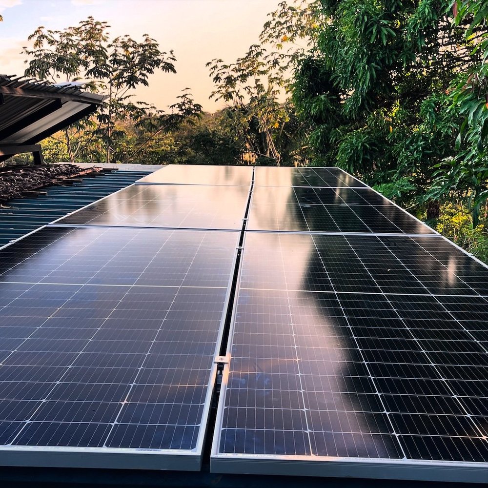 Six visible solar panels on the roof of the residential case study in Santiago, Costa Rica